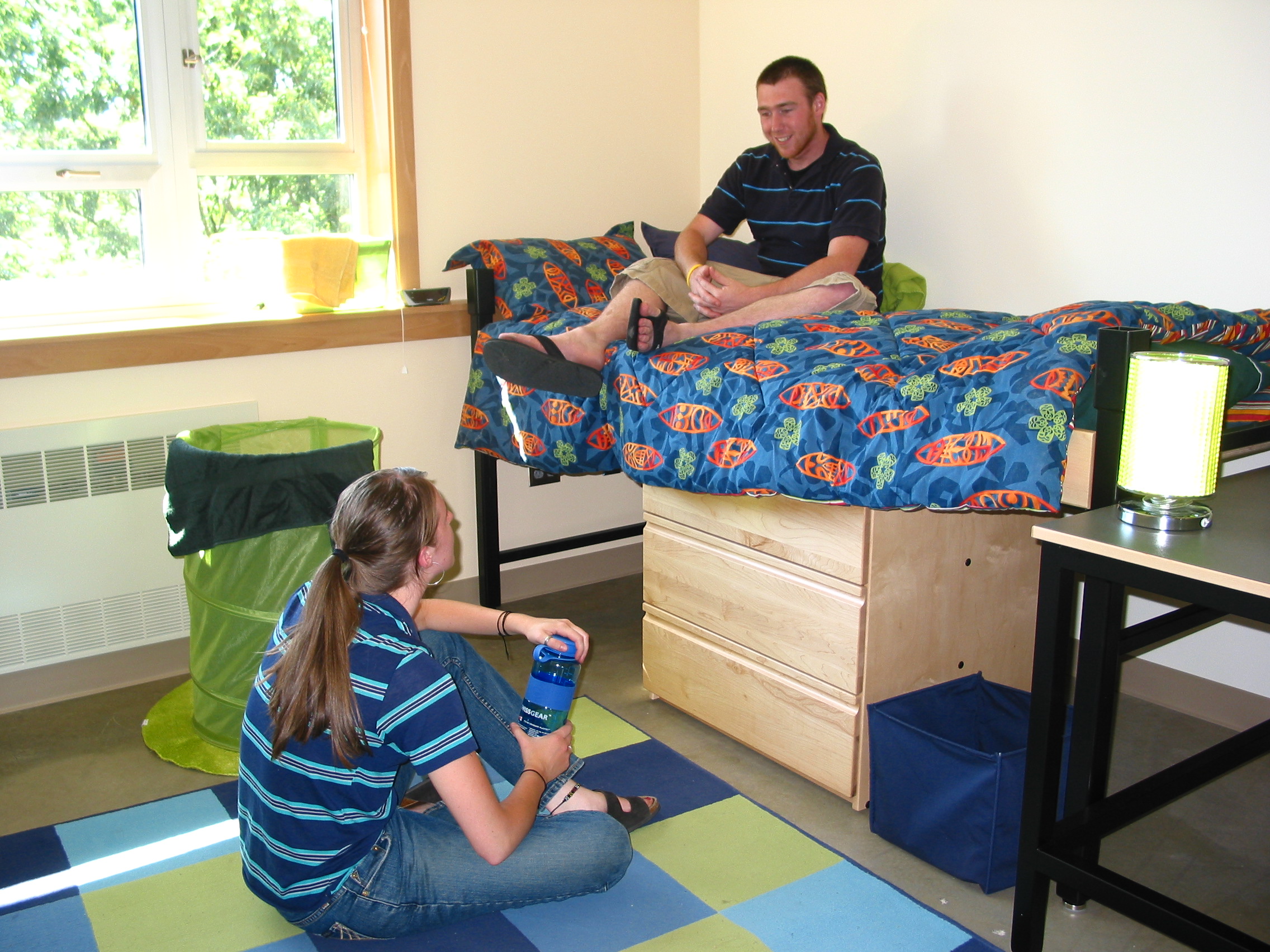 two people talking in a dorm room