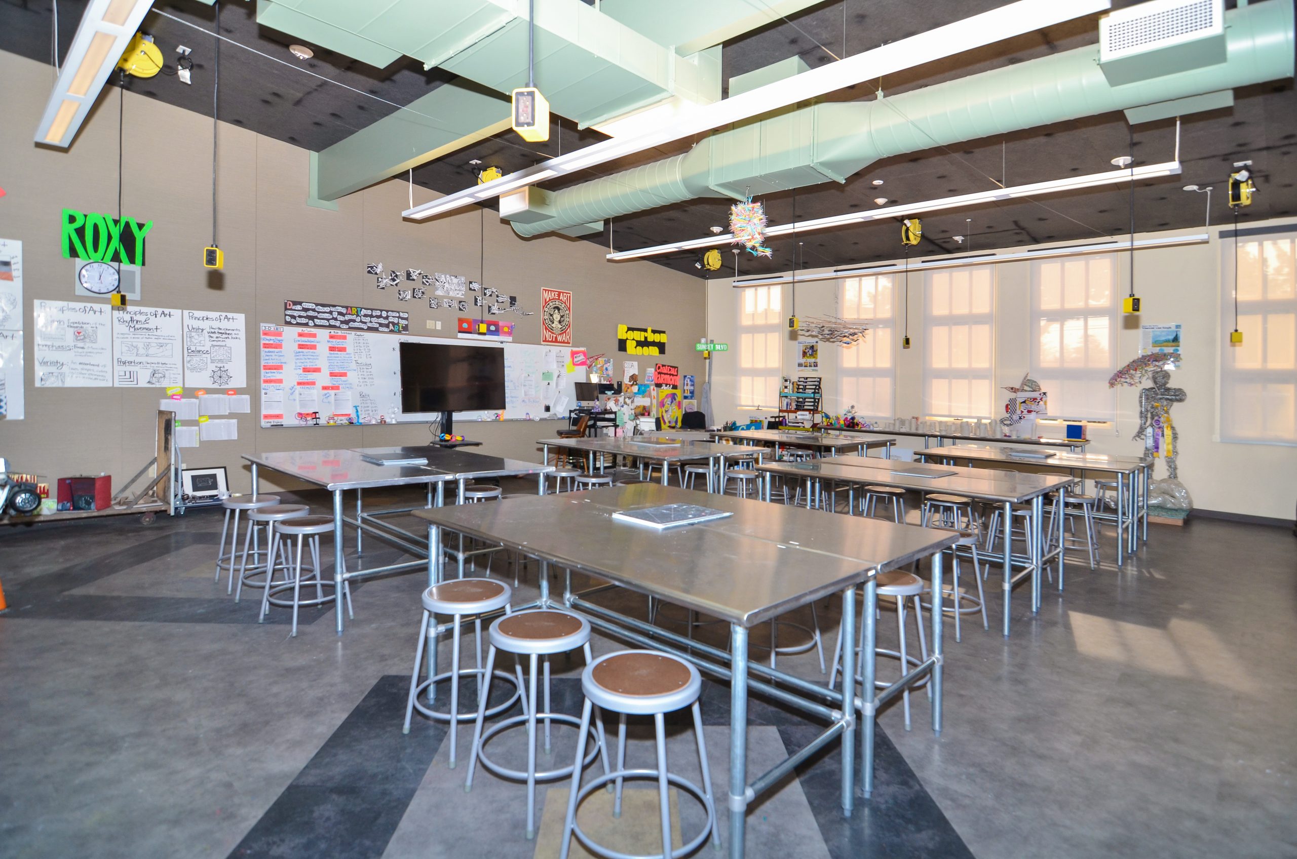 a large kitchen with tables and stools