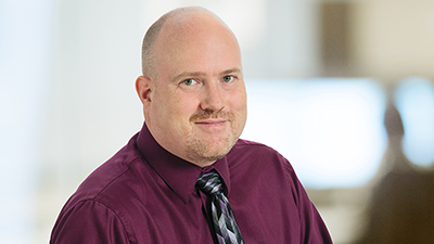 a man in a red shirt and tie