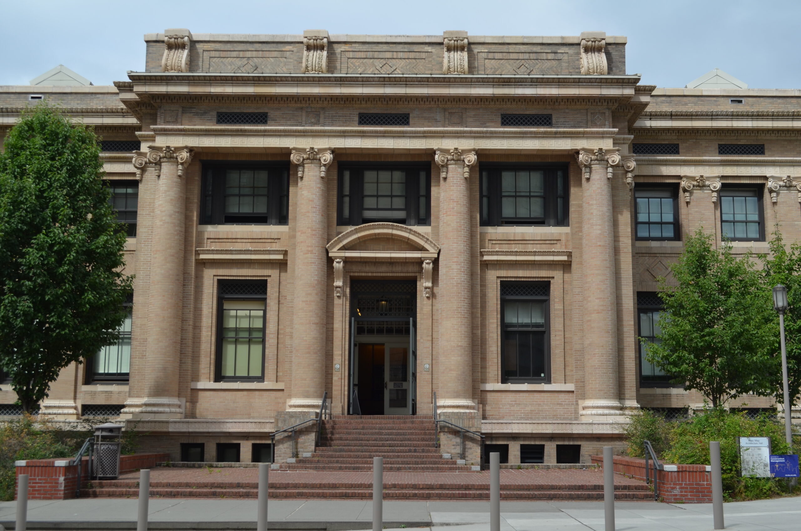 a large building with pillars and a staircase in front