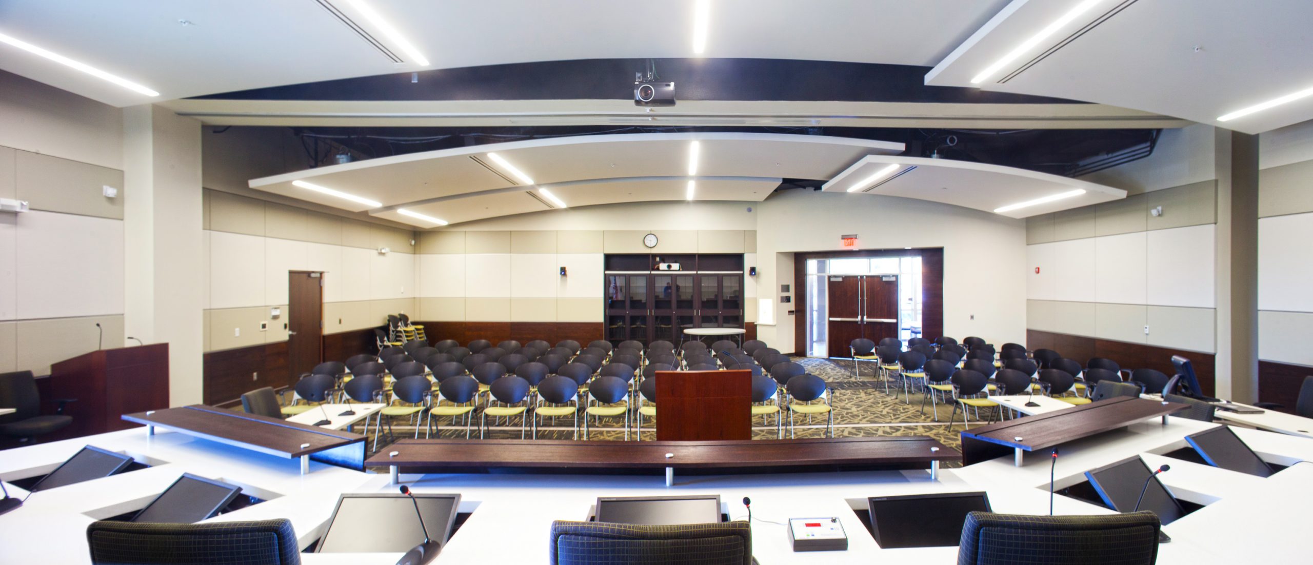 a room with a large group of desks and a large window