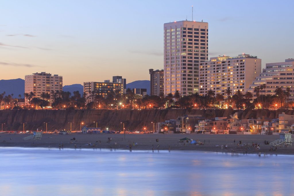 a city skyline with a body of water in the foreground