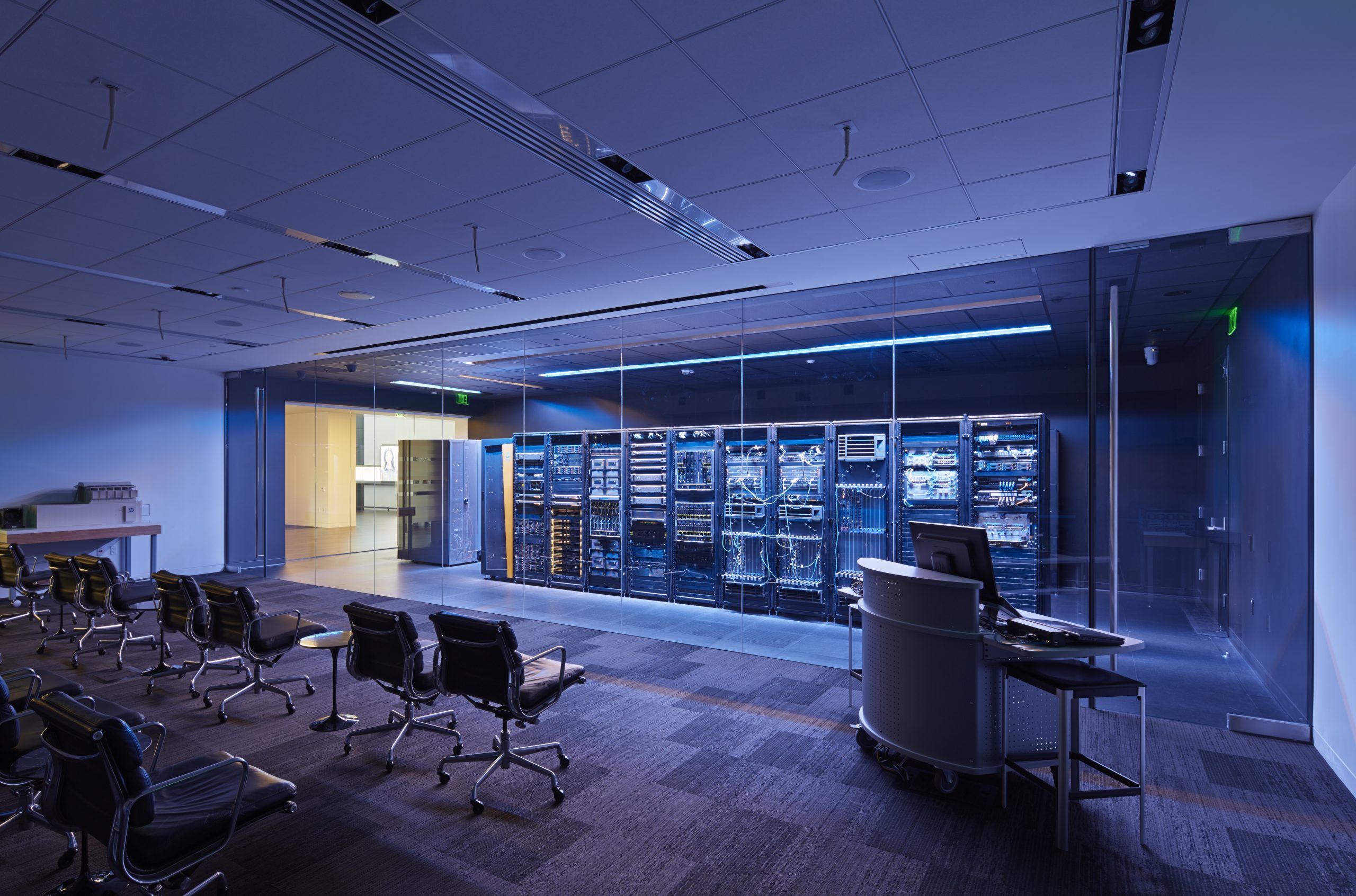 a room with many computers and chairs