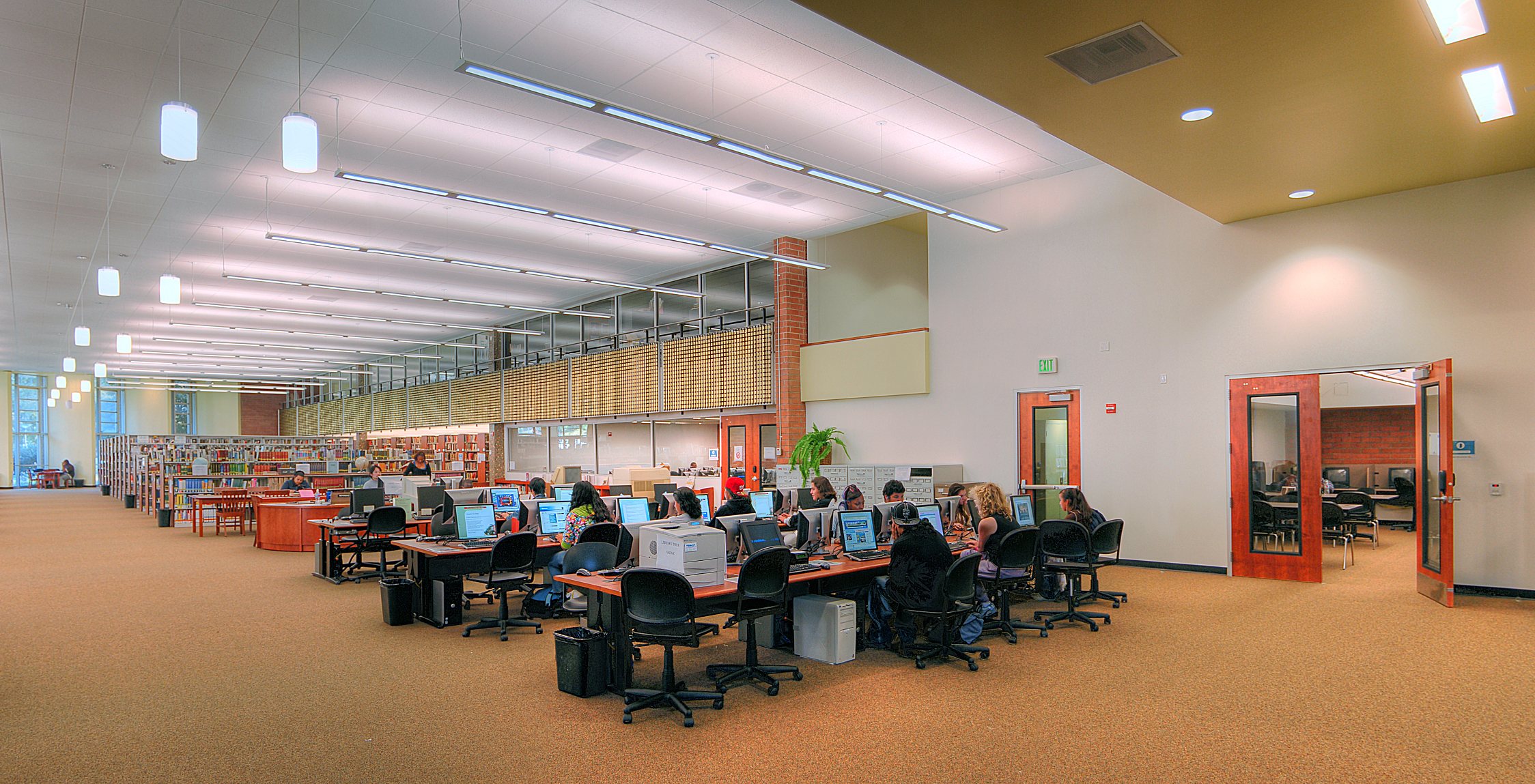 a group of people sitting at desks in a room