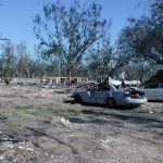 damaged cars surrounded by debris