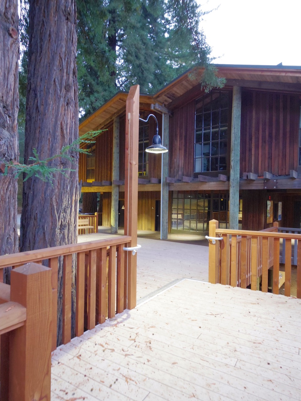 a wooden building with a fence around it