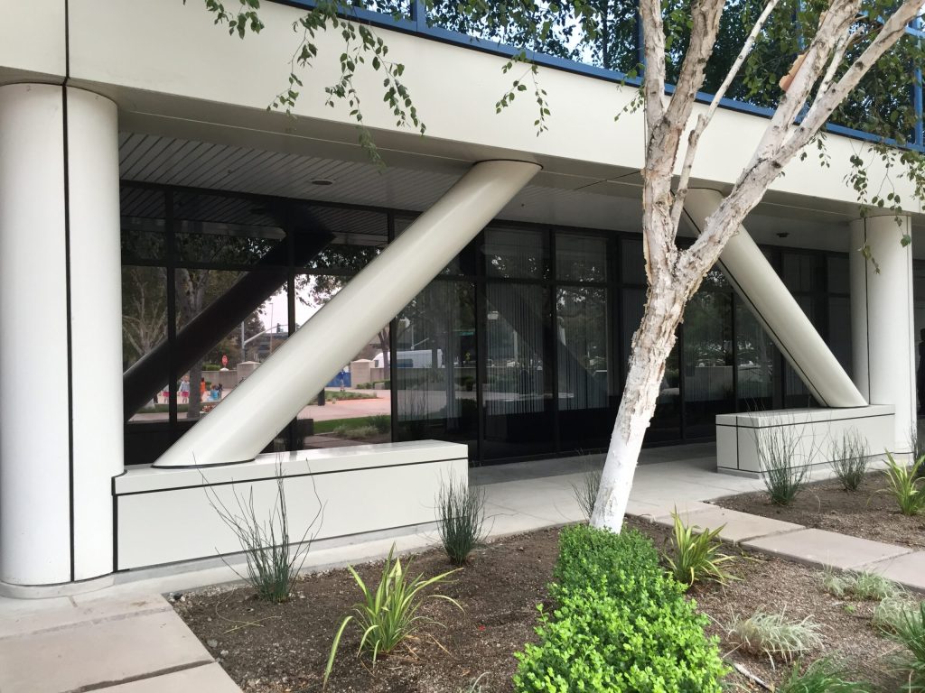 entrance to a building with a tree in front