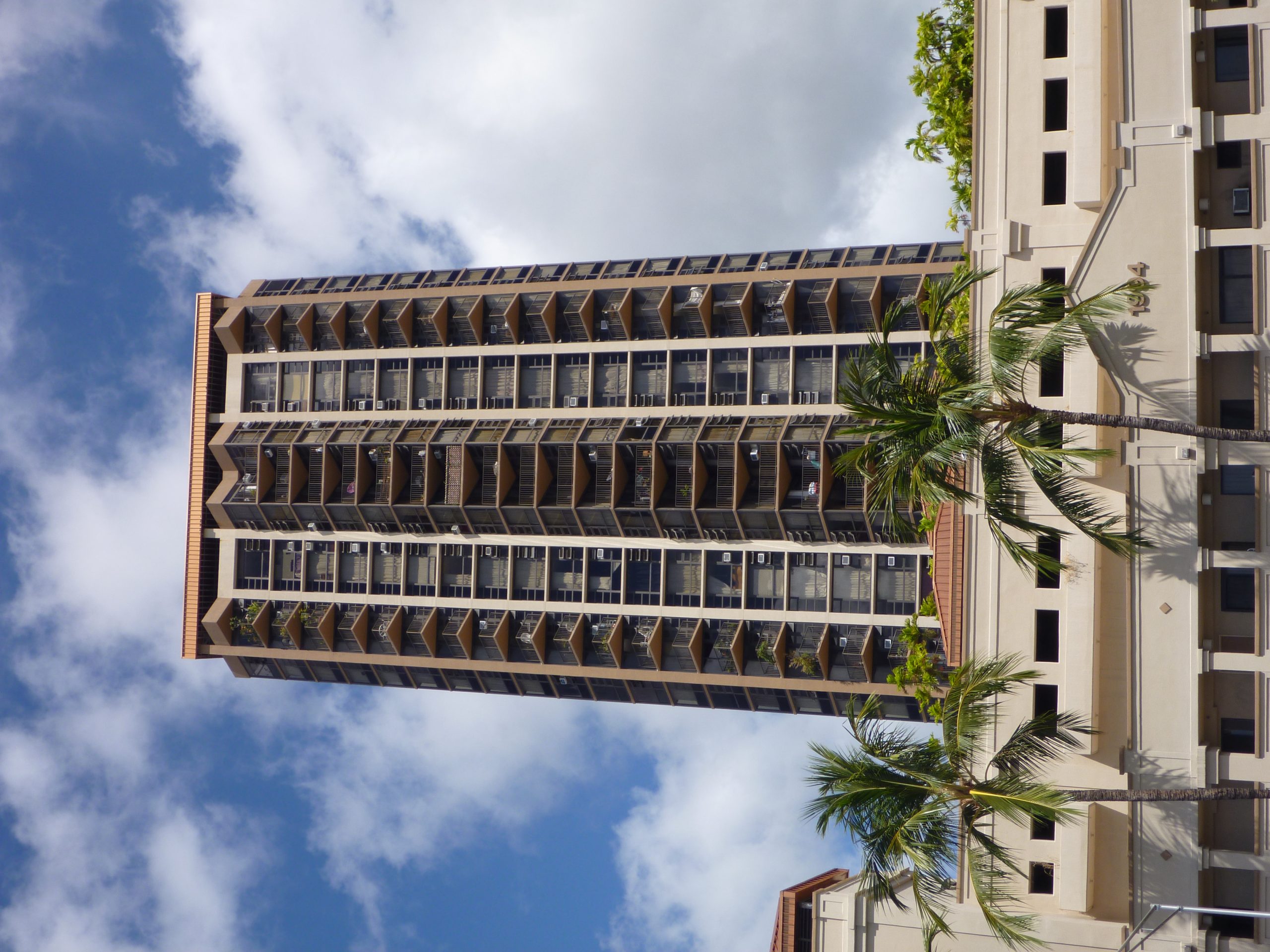 a tall building with a tree in front of it