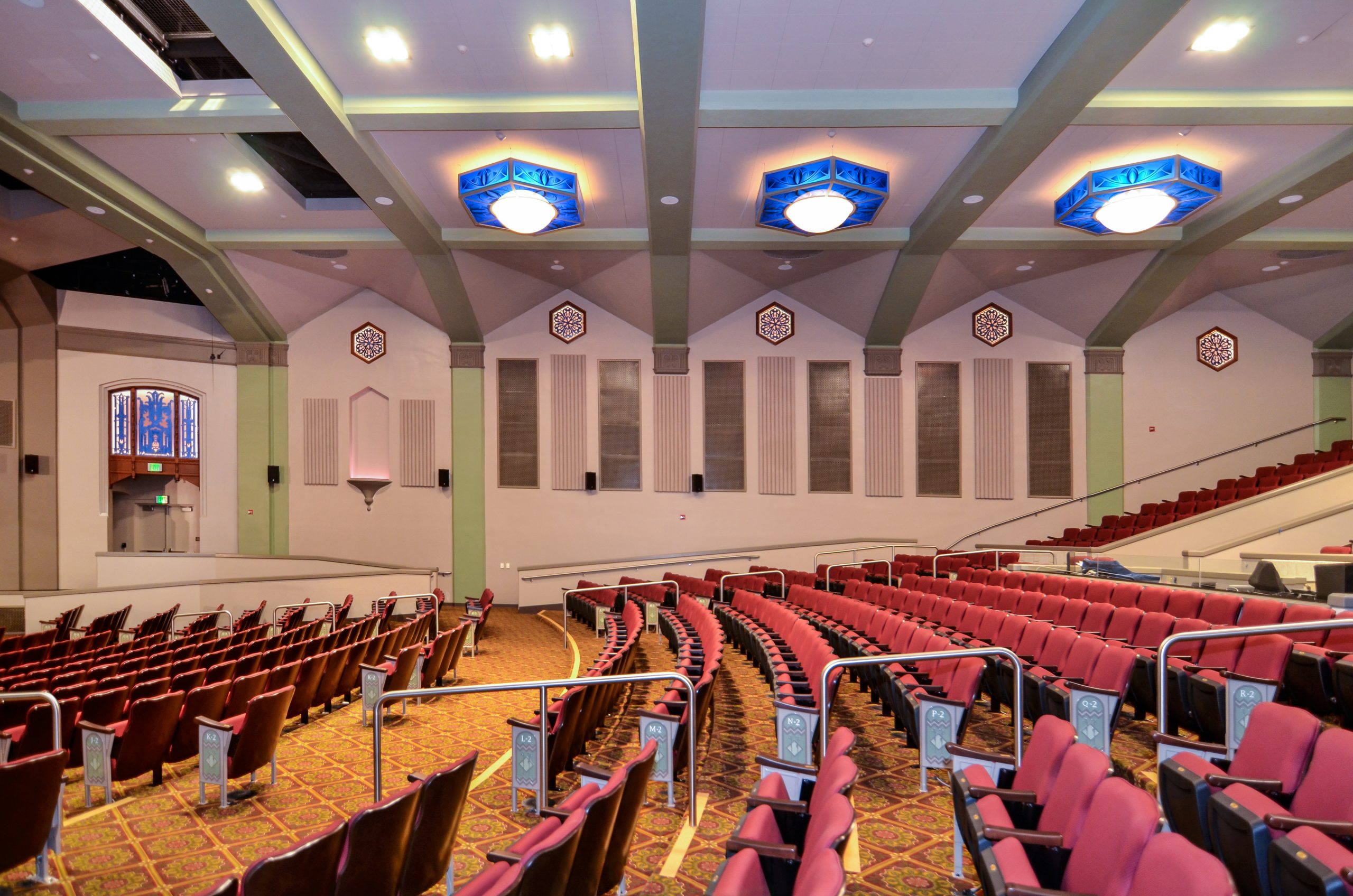 a church with red chairs and red seats