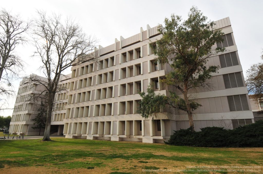 a large white building with trees in front of it