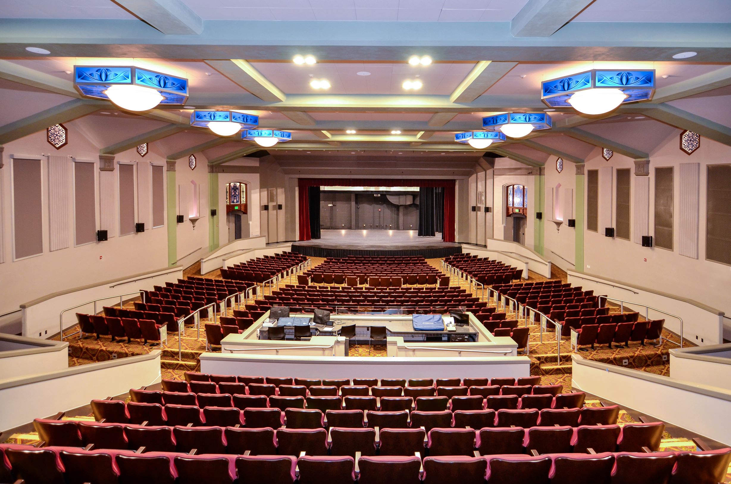 a room with a large stage and a row of seats