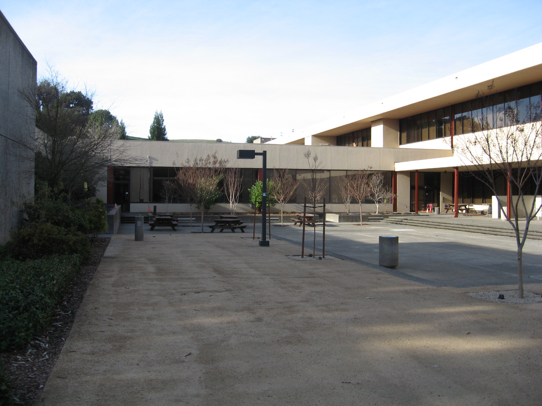 a courtyard with buildings and trees