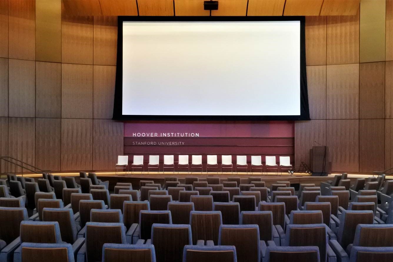 a large room with chairs and a large screen