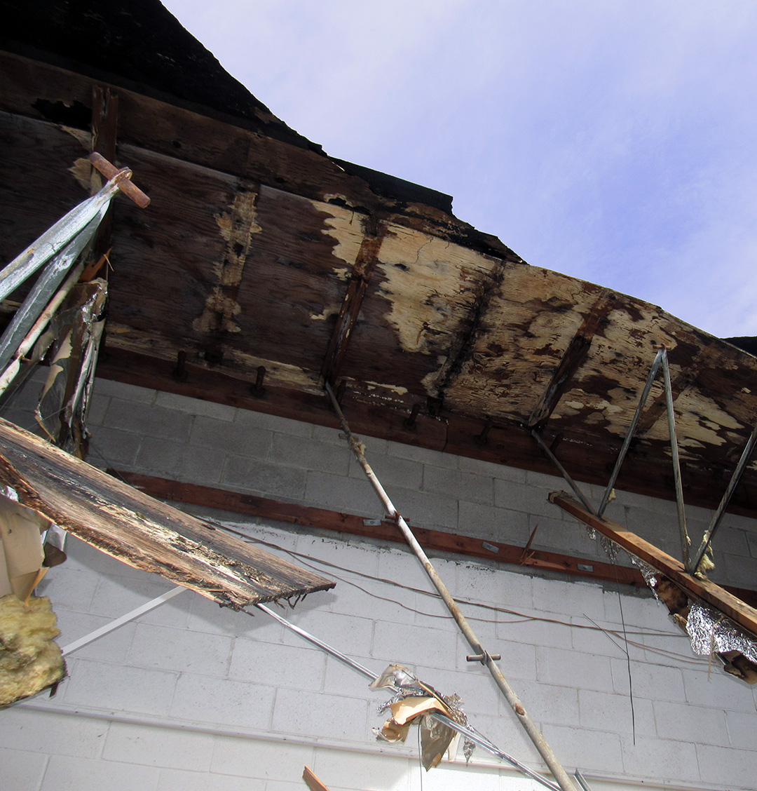 a large brick building with a broken roof