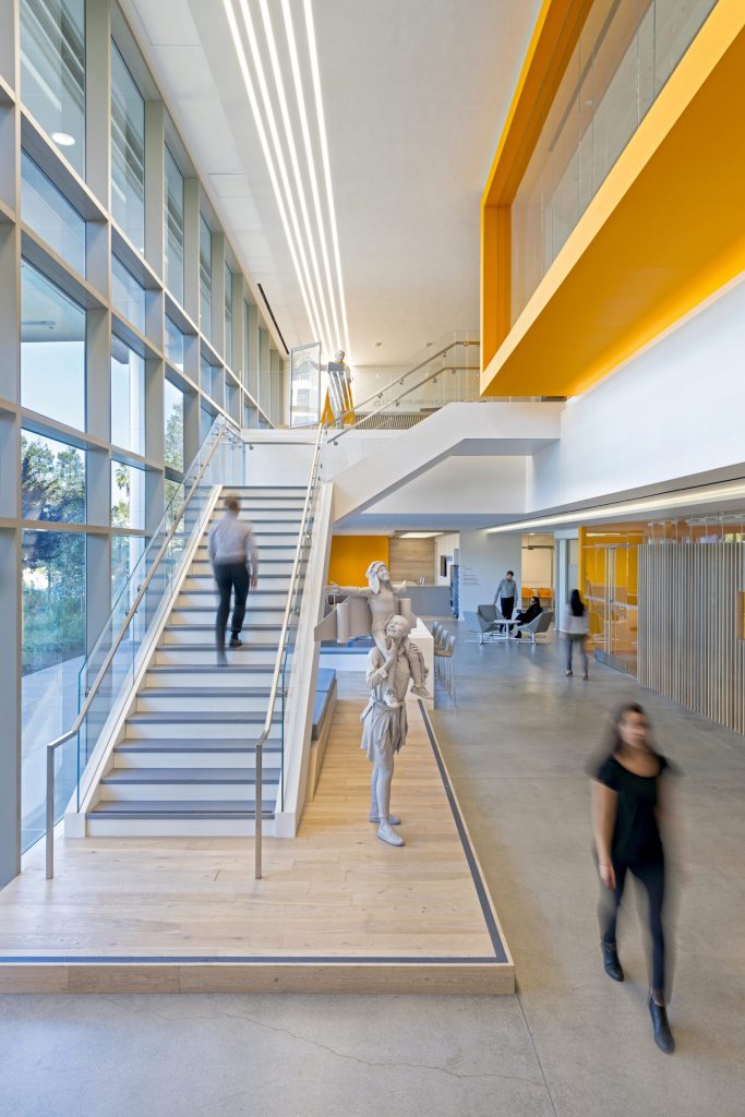 a group of people walking down a hall way