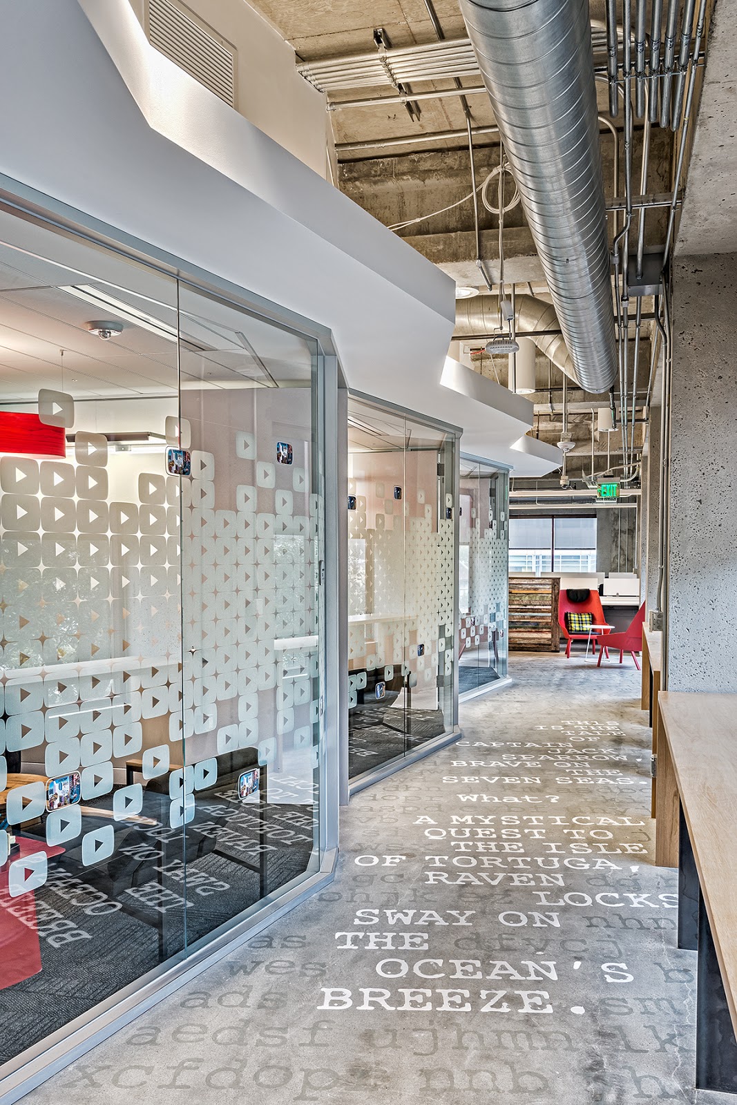 a long hallway with glass walled offices