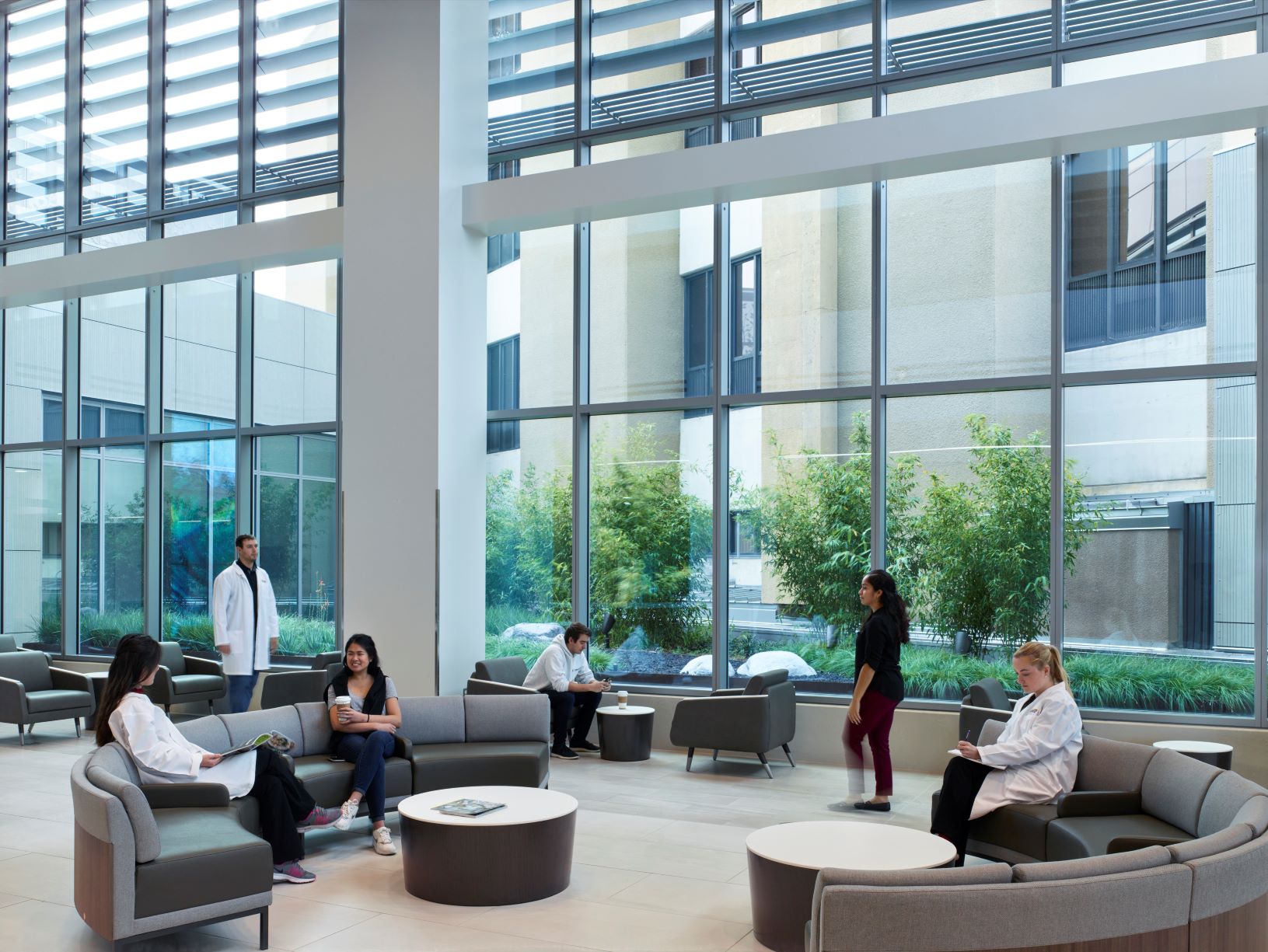 a group of people sitting in a room with windows