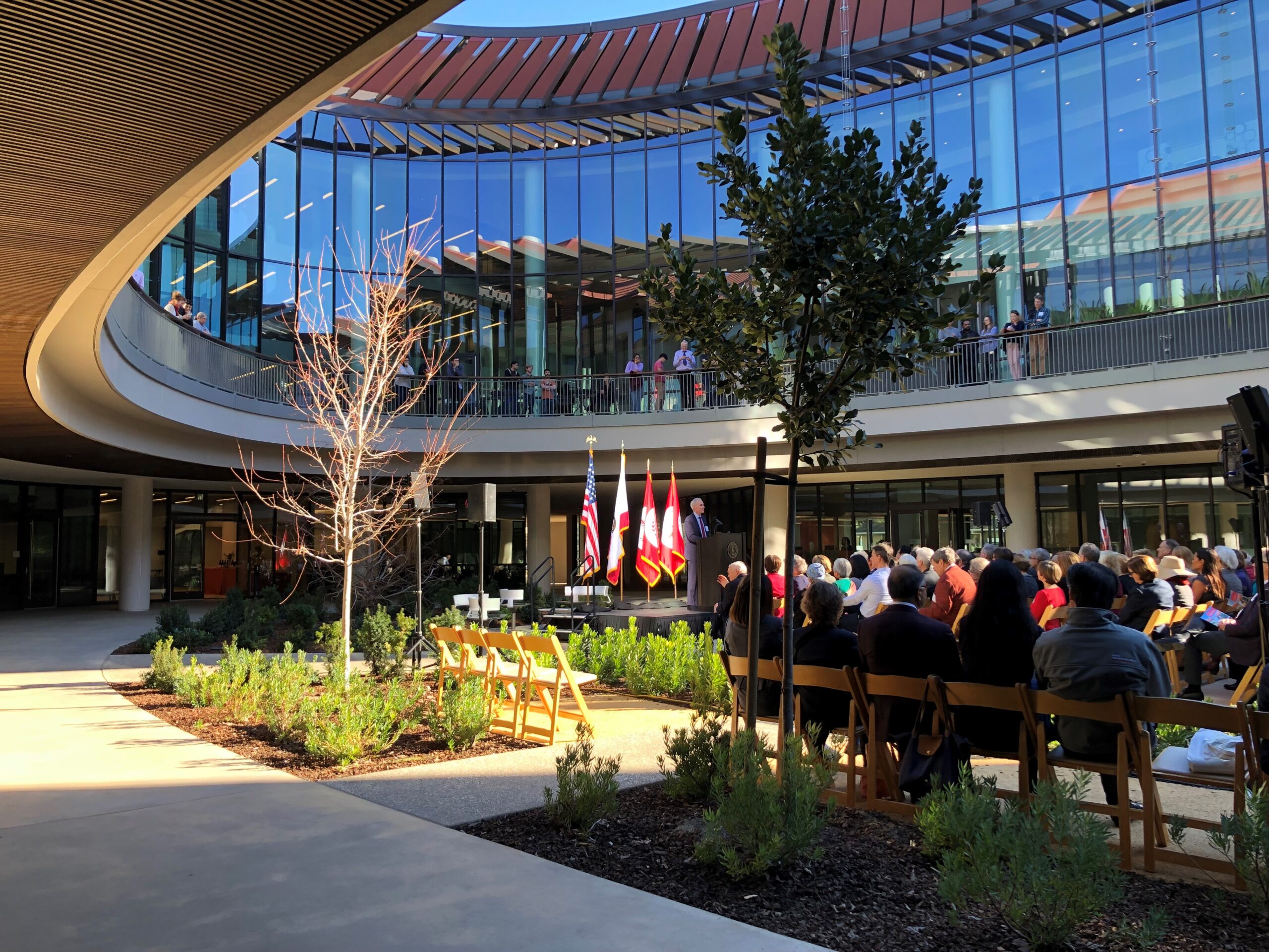 a group of people sitting at tables outside a building