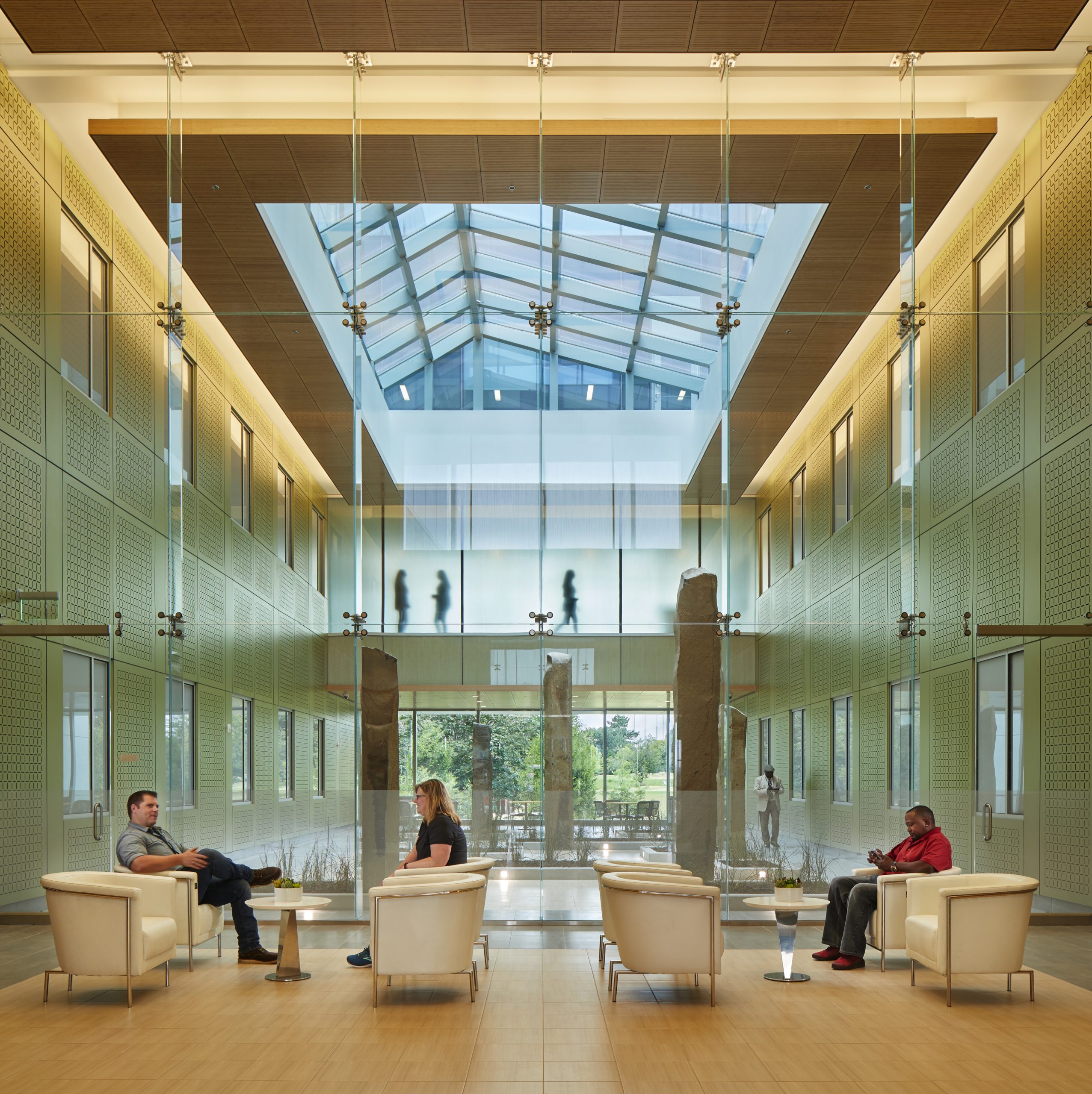 a group of people sitting in a room with large windows